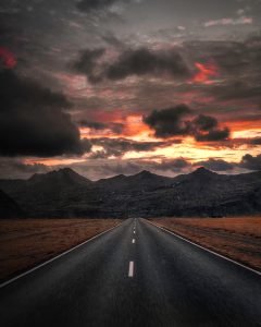 Sunsetting over a highway focusing into the mountains